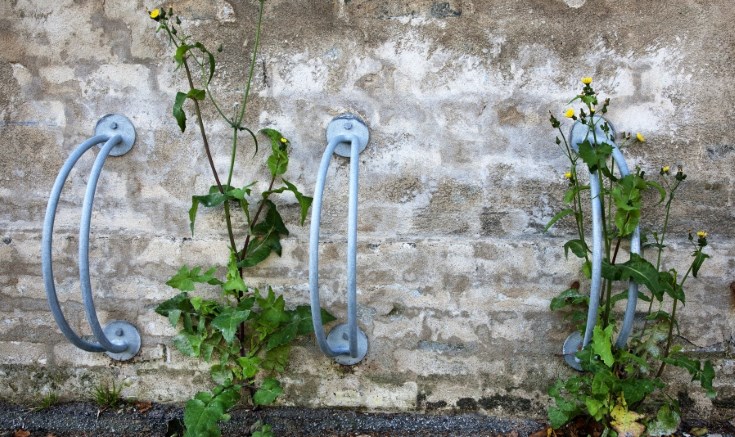 Bicycle racks on a wall. Photo.